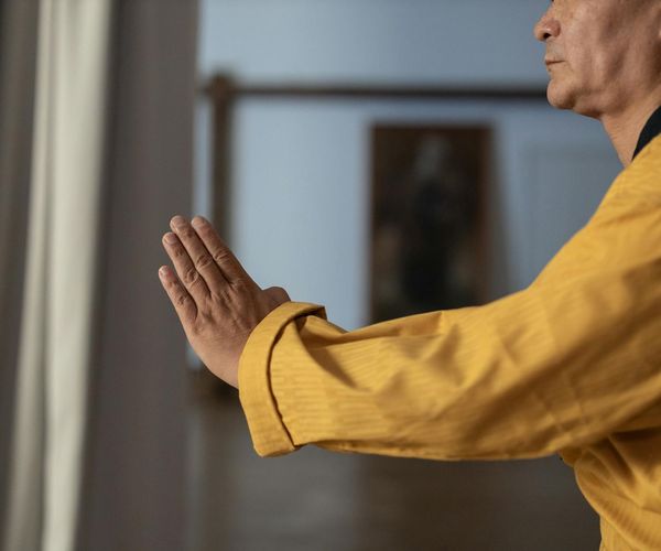 Man focused on a balancing pose, demonstrating concentration and control.